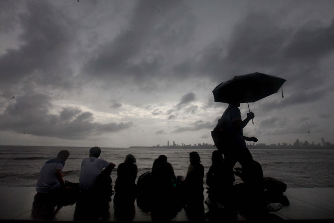 आकाशात दाटलेले मेघ आणि मुंबईच्या मरिन ड्राईव्हवर पावसाचा आनंद लुटण्यासाठी सज्ज असलेली तरुणाई. (छाया- वसंत प्रभू)