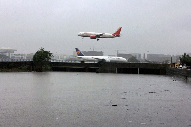 मुंबईत मुसळधार पाऊस सुरू असताना मिठी नदीवरून जाणाऱ्या विमानांचे टिपलेले छायाचित्र. (छाया- पीटीआय)