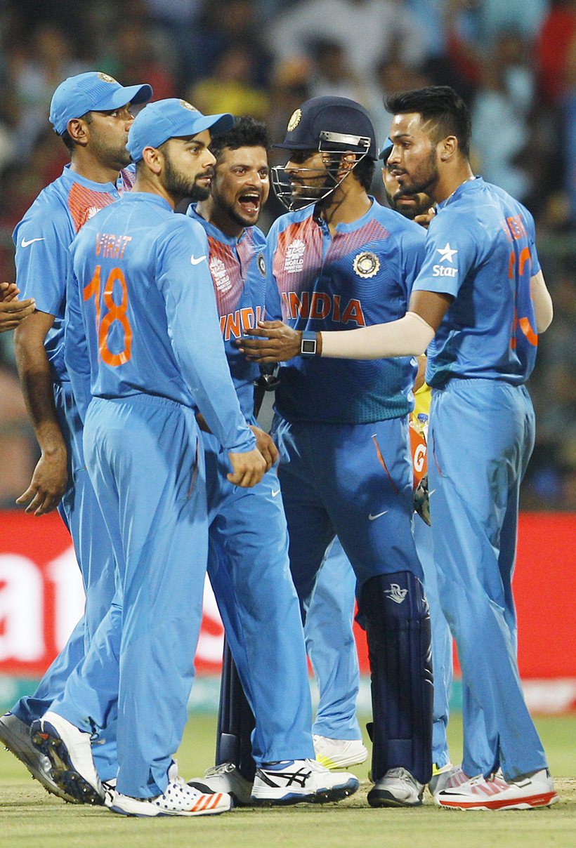 India's Suresh Raina, center, celebrates with teammates after dismissing Bangladesh's Sabbir Rahman during their ICC World Twenty20 2016 cricket match in Bangalore, India, Wednesday, March 23, 2016. (AP Photo/Aijaz Rahi)