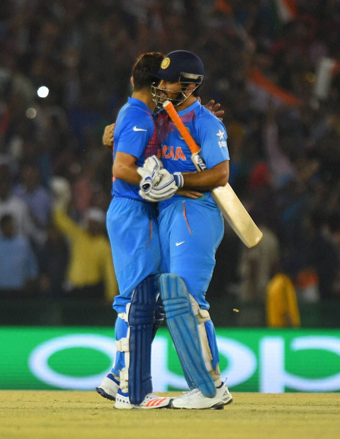 India's captain Mahendra Singh Dhoni (R) speaks with his teammate Virat Kohli. REUTERS