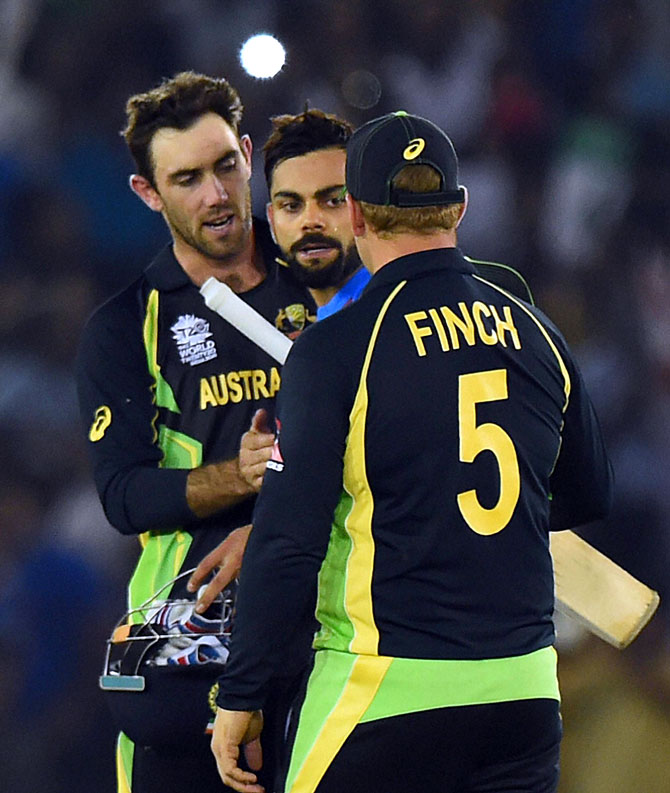 Indian batsman Virat Kohli greeted by Australian players after winning the ICC World T20 match against Australia at PCA cricket stadium in Mohali on Sunday. PTI