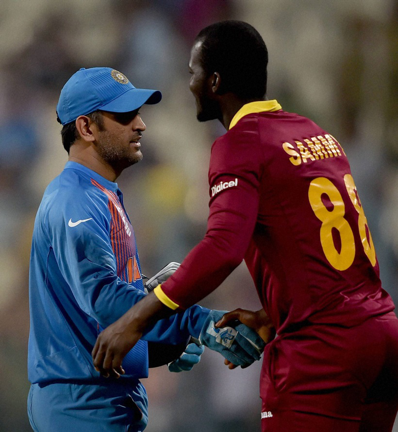 Kolkata: Indian skipper M S Dhoni and Darren Sammy captain of West Indies greet each other after a warm-up match at Eden Garden in Kolkata on Thursday. India won the match. PTI Photo by Swapan Mahapatra(PTI3_10_2016_000341A)