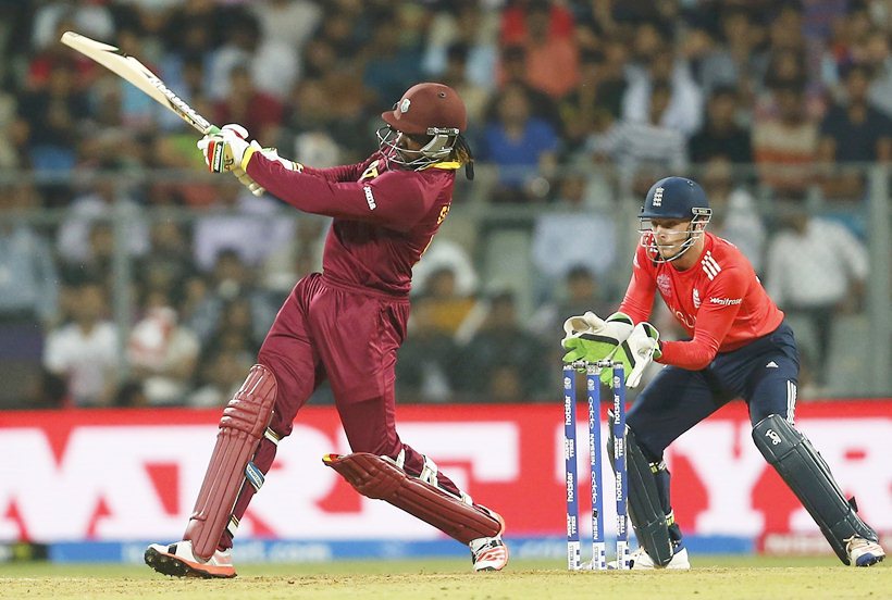 Cricket - West Indies v England - World Twenty20 cricket tournament - Mumbai, India, 16/03/2016. West Indies Chris Gayle (L) plays a shot as England's wicketkeeper Jos Buttler looks on. REUTERS/Danish Siddiqui