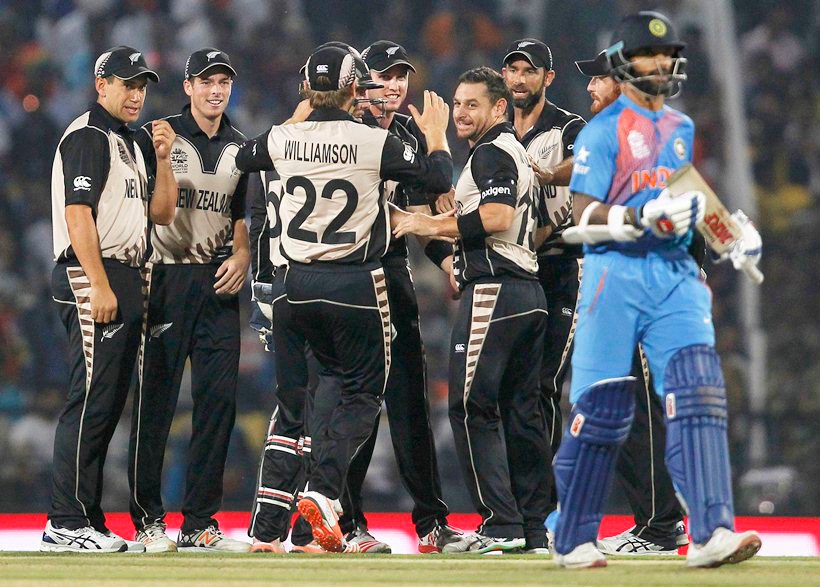 Cricket - New Zealand v India - World Twenty20 cricket tournament - Nagpur, India, 15/03/2016. New Zealand's Nathan McCullum (4th R) is congratulated by his teammates after he took the wicket of India's Shikhar Dhawan. REUTERS/Danish Siddiqui