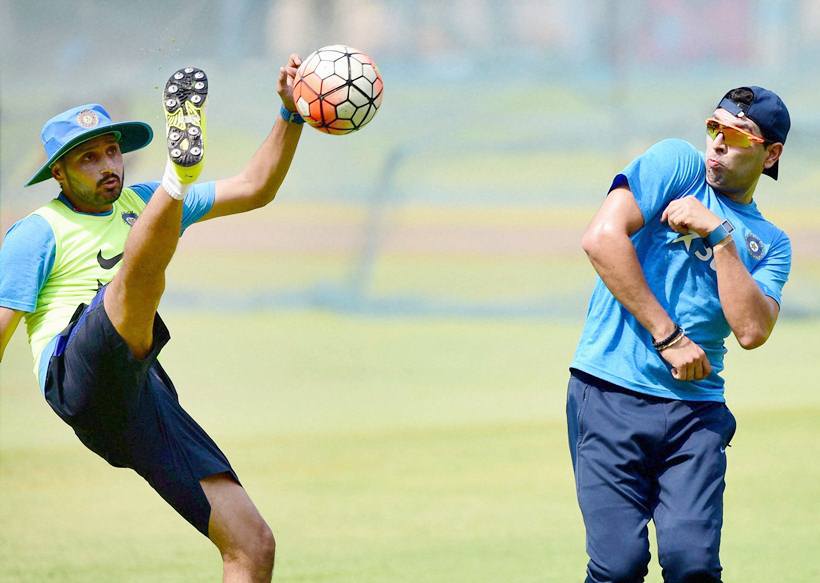 Bengaluru: Cricketers Harbhajan Singh and Yuvraj Singh play a game of soccer during a training session at Chinnaswamy Stadium in Bengaluru on Tuesday. PTI Photo by Shailendra Bhojak (PTI3_22_2016_000230B)