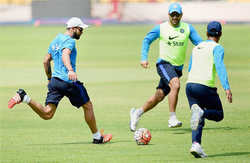 Bengaluru: Virat Kohli and M S Dhoni play a game of soccer during a training session at Chinnaswamy Stadium in Bengaluru on Tuesday. PTI Photo by Shailendra Bhojak (PTI3_22_2016_000211A) *** Local Caption ***