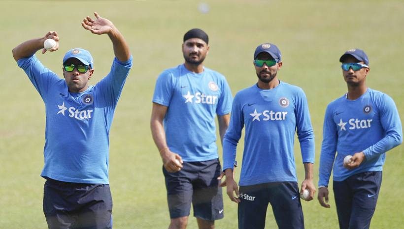 India's Ravichandran Ashwin, left, bowls in the nets as teammates, from right, Pawan Negi, Ravindra Jadeja and Harbhajan Singh wait for their turn during a training session ahead of their ICC World Twenty20 2016 match against Bangladesh in Bangalore, India, Tuesday, March 22, 2016. (AP Photo/Aijaz Rahi)