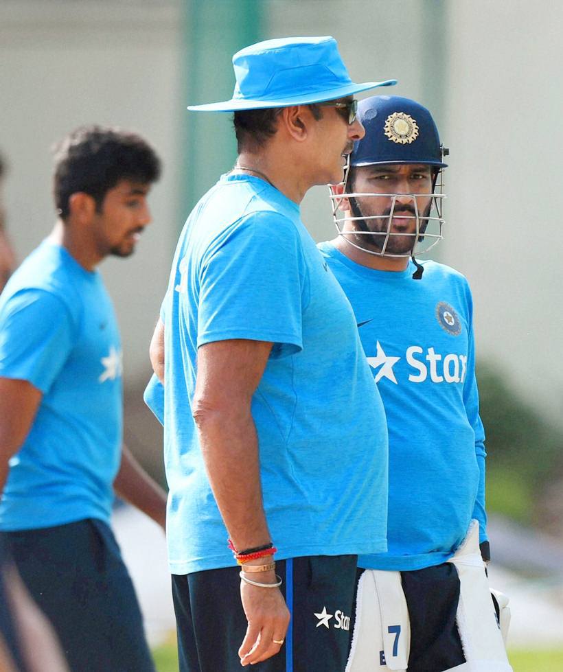 Mohali: India's captain M S Dhoni with team director Ravi Shastri during a practice session in Mohali on Saturday ahead of the crucial ICC World Twenty20 clash with Australia. PTI Photo by Shahbaz Khan (PTI3_26_2016_000199A)