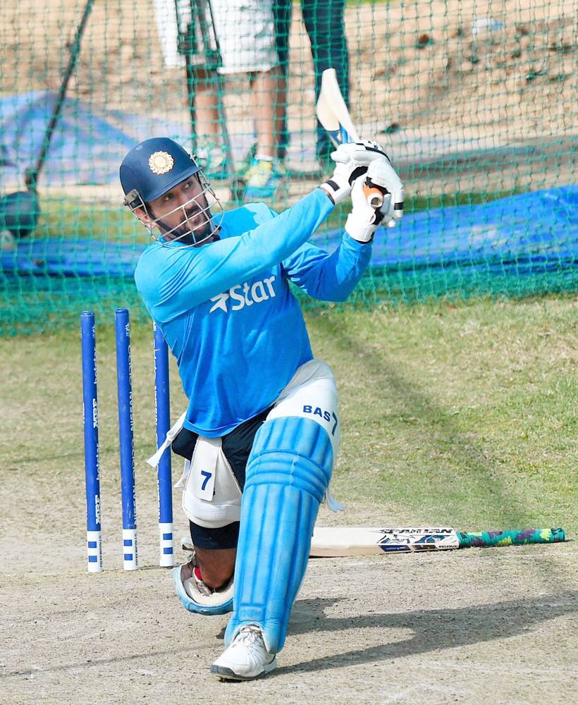 Mohali: Skipper MS Dhoni bats in the nets during a training session n Mohali on Saturday. PTI Photo by Shahbaz Khan (PTI3_26_2016_000192B)