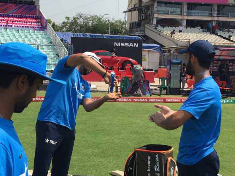 Suresh Raina seems very generous while applying the solution. The elegant southpaw seems worried about the tan. (Source: Twitter)