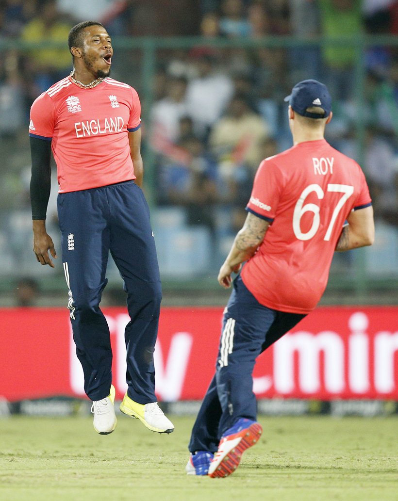 England's Chris Jordan, left, celebrates after dismissing Sri Lanka's Dinesh Chandimal during their ICC World Twenty20 2016 cricket match at the Feroz Shah Kotla cricket stadium in New Delhi, India, Saturday, March 26, 2016. (AP Photo /Tsering Topgyal)