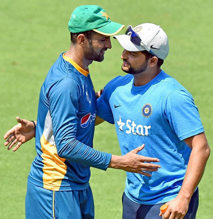 Suresh Raina greets Pakistan's Shoaib Malik during the net session. Malik a India connection because of his marriage to Sania Mirza - India's ace tennis player. (Source: PTI
