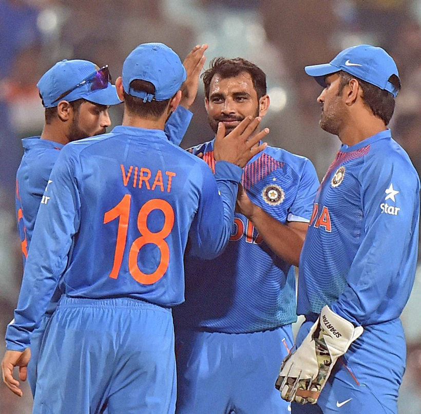 Kolkata: India's bowler Shami celebrate a wicket against West Indies with captain M S Dhoni and other team mates during a warm-up match at Eden Garden in Kolkata on Thursday. PTI Photo by Ashok Bhaumik (PTI3_10_2016_000339B)