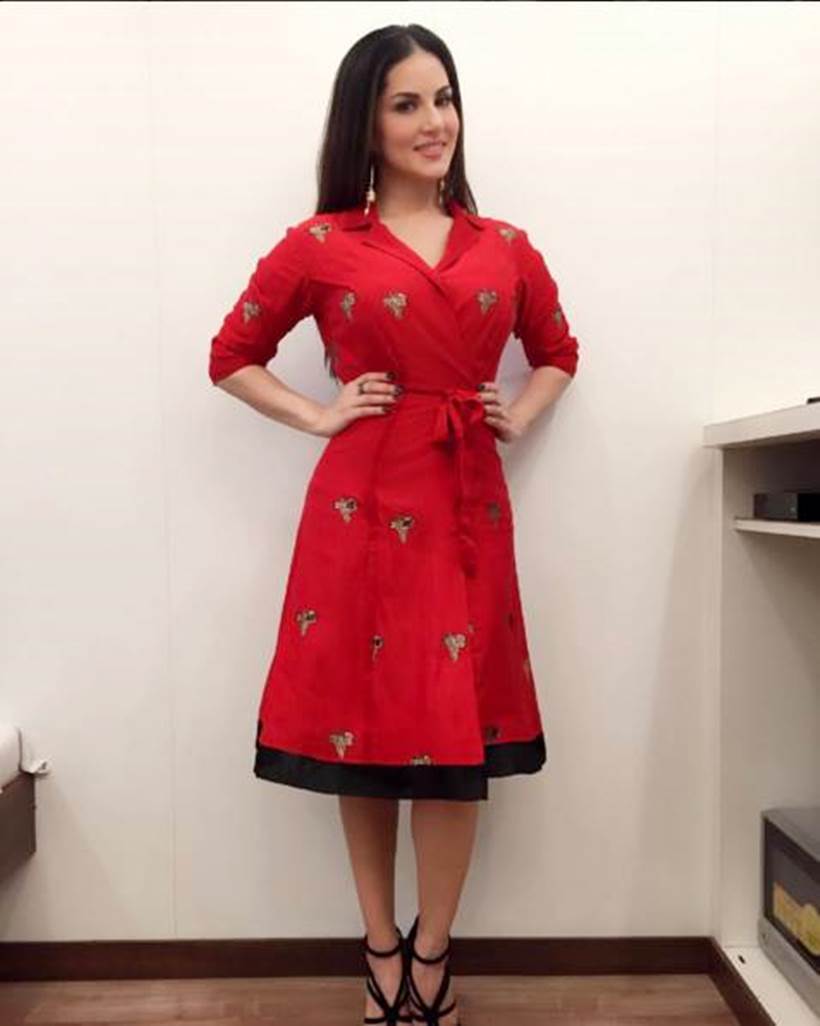 Sunny Leone picked a red Rinku Sobti wrap dress for a recent appearance. The actor wore it well with a pair of strappy black heels. (Photo: Sunny Leone/Facebook)