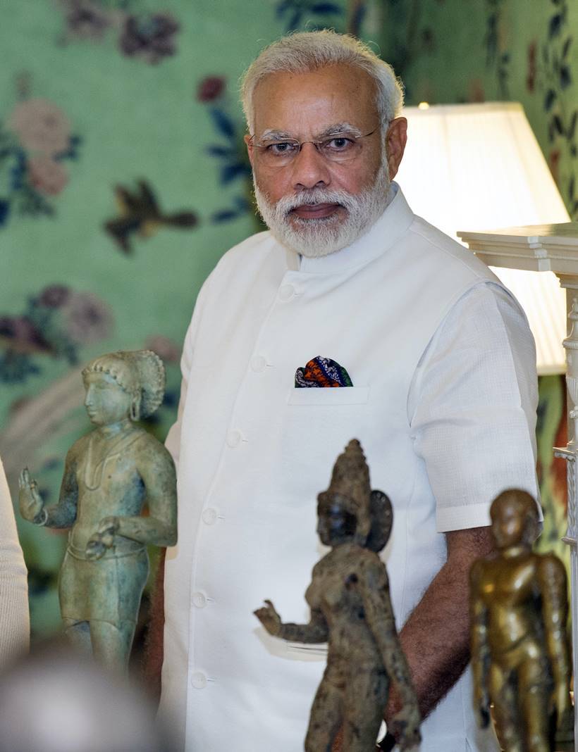 Indian Prime Minister Narendra Modi stands with three statues during a ceremony marking the repatriation of over 200 artifacts to the Indian government, in Washington, Monday, June 6, 2016. The majority of the pieces repatriated were seized during Operation Hidden Idol, which began in 2007 after Homeland Security Investigators received a tip about a shipment of seven crates destined for the U.S.. Statues from left: Idol of Saint Manikkavichavakar also known as Sampanthar, Parvati, from South India, Tamil Nadu Chola Dynasty 12th century, and Jain Figure of Bahubali, from South India, probably Karnataka 14th century. (AP Photo)