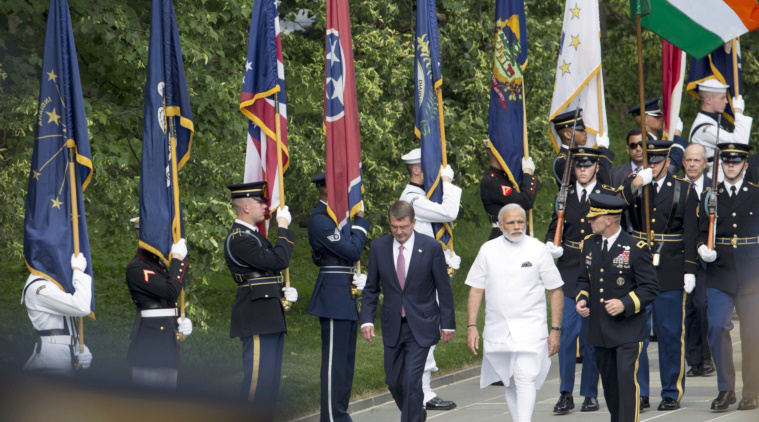 Indian Prime Minister Narendra Modi, center, with Secretary of Defense Ash Carter, left, and, Maj. Gen. Bradley Becker, right, arrive to lay a wreath at the Tomb of the Unknowns at Arlington National Cemetery, in Arlington, Va., Monday, June 6, 2016. (AP Photo)