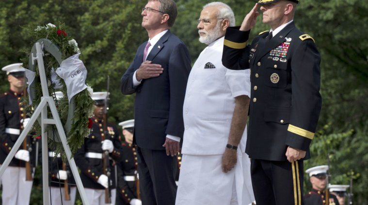 Indian Prime Minister Narendra Modi, center, with Secretary of Defense Ash Carter, left, and, Maj. Gen. Bradley Becker, right, lays a wreath at the Tomb of the Unknowns at Arlington National Cemetery, in Arlington, Va., Monday, June 6, 2016. (AP Photo)