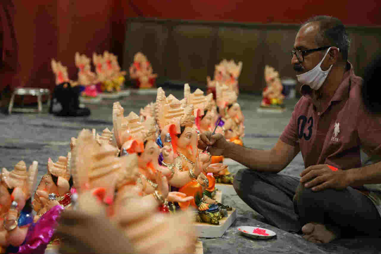 पुण्यातील राजेंद्र देशमुख यांच्यासह त्यांची टीम कारखान्यामध्ये गणेशाच्या मूर्ती तयार करीत आहेत.