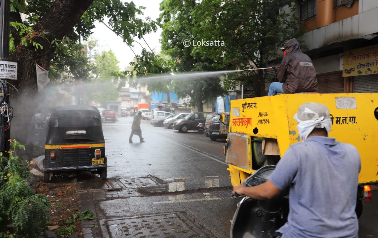 PMC municipal worker sanitizing roadside