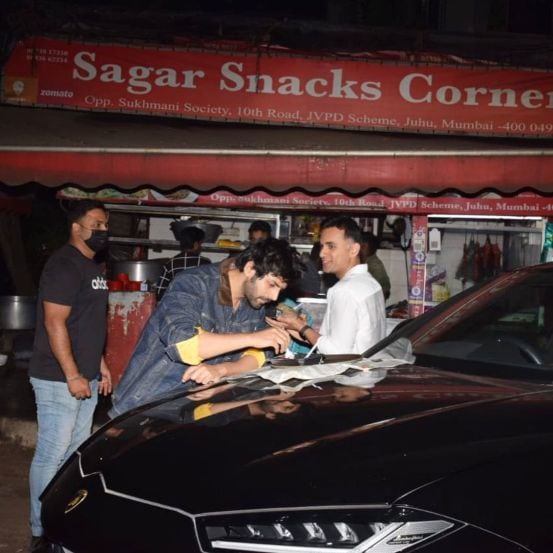 Chinese van food on Lamborghini bonnet Kartik Aaryan roadside foodscape on way back from Bigg Boss 15