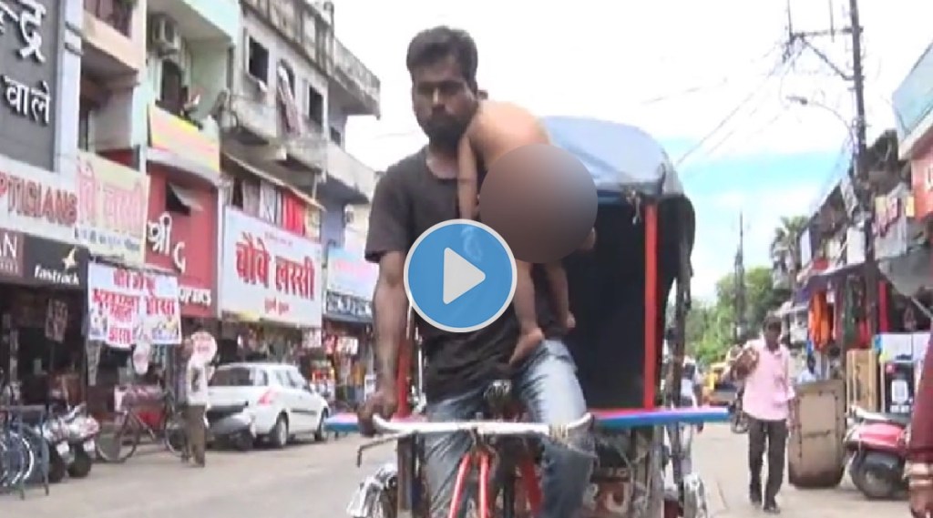 A father has to drive a rickshaw with a one-year-old baby on his shoulder