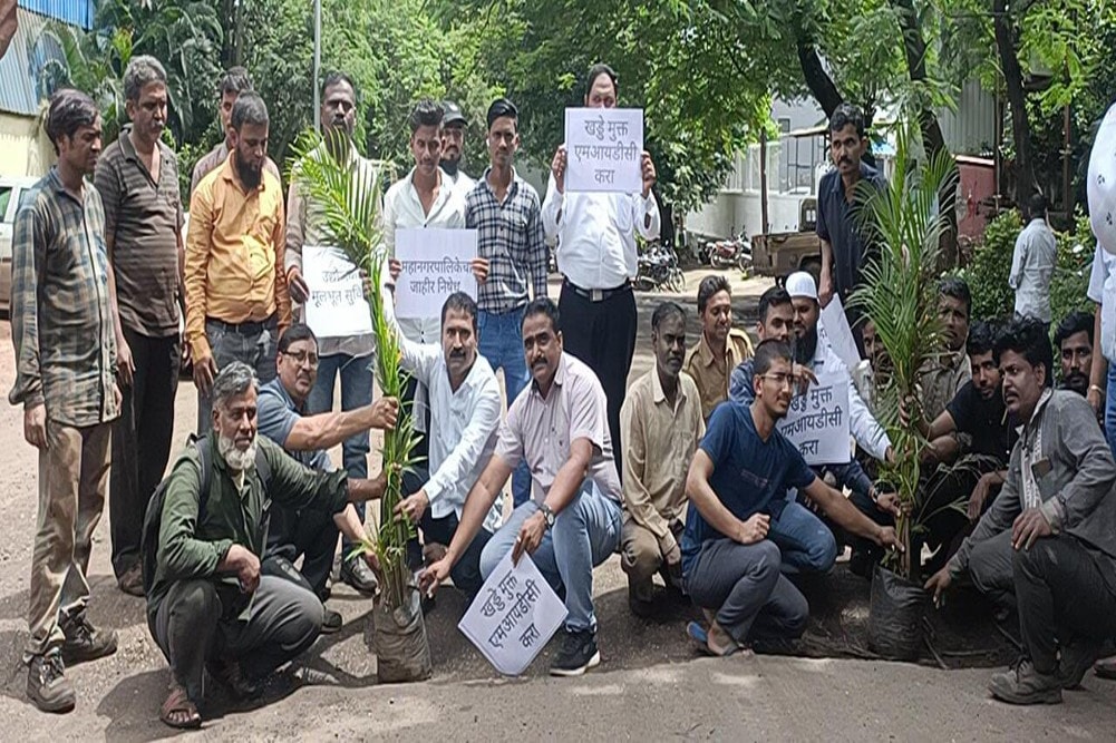 Protest by entrepreneurs and workers by planting trees in potholes on roads at bhosari in pimpri