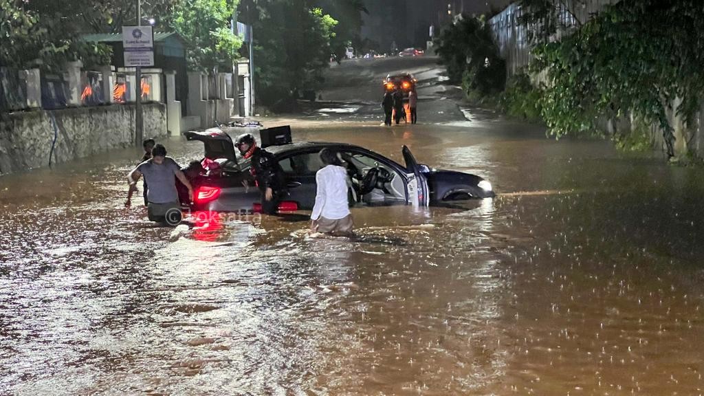 Pune Rain Photos A BMW 5 series car held on a submerged road near Vibgyor school at NIBM annex