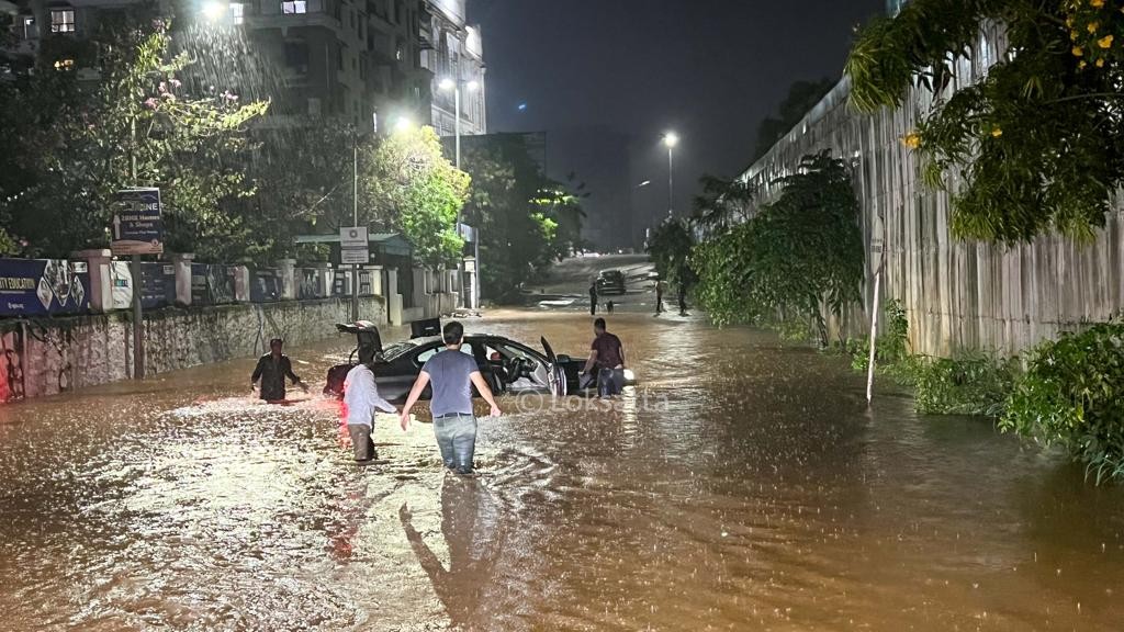 Pune Rain Photos A BMW 5 series car held on a submerged road near Vibgyor school at NIBM annex