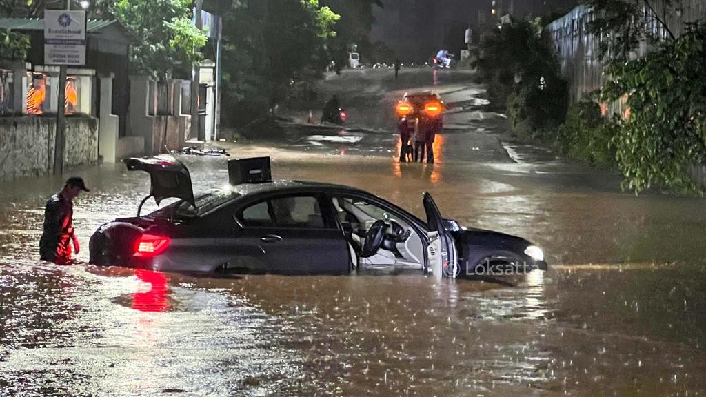 Pune Rain Photos A BMW 5 series car held on a submerged road near Vibgyor school at NIBM annex