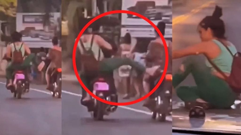 Lady Falls While Trying to Kick another Bike Rider