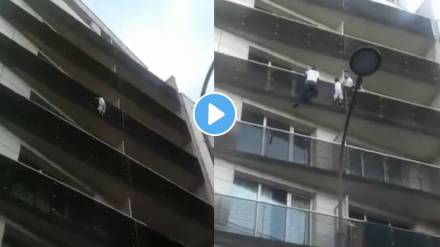 Man climbs building to save dangling child