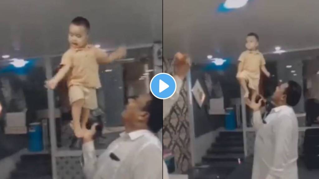 little boy dancing on palm of grandfather