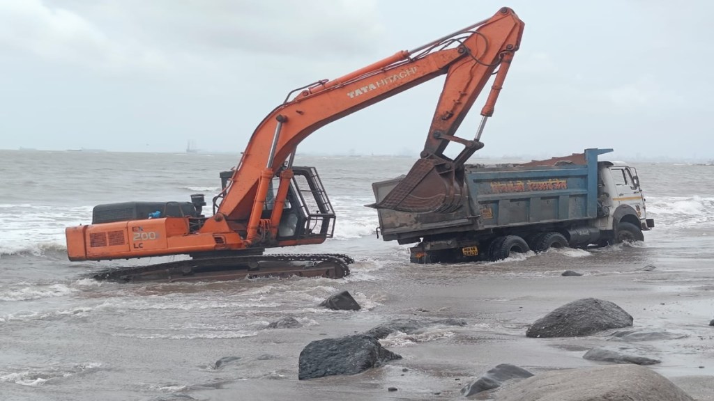 dumper carrying stones stuck in sand