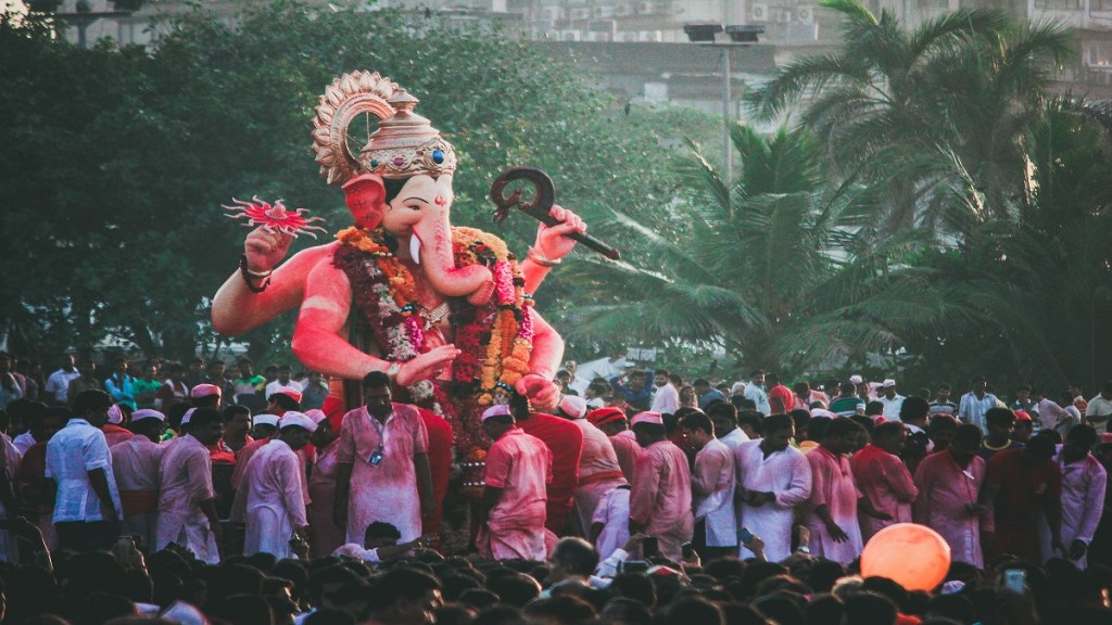 Volunteers immersing Ganesh idols