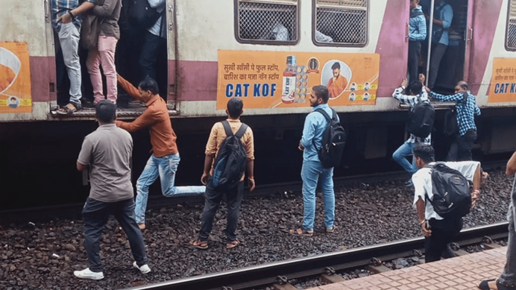 Passengers board local opposite door standing railway line diva railway station