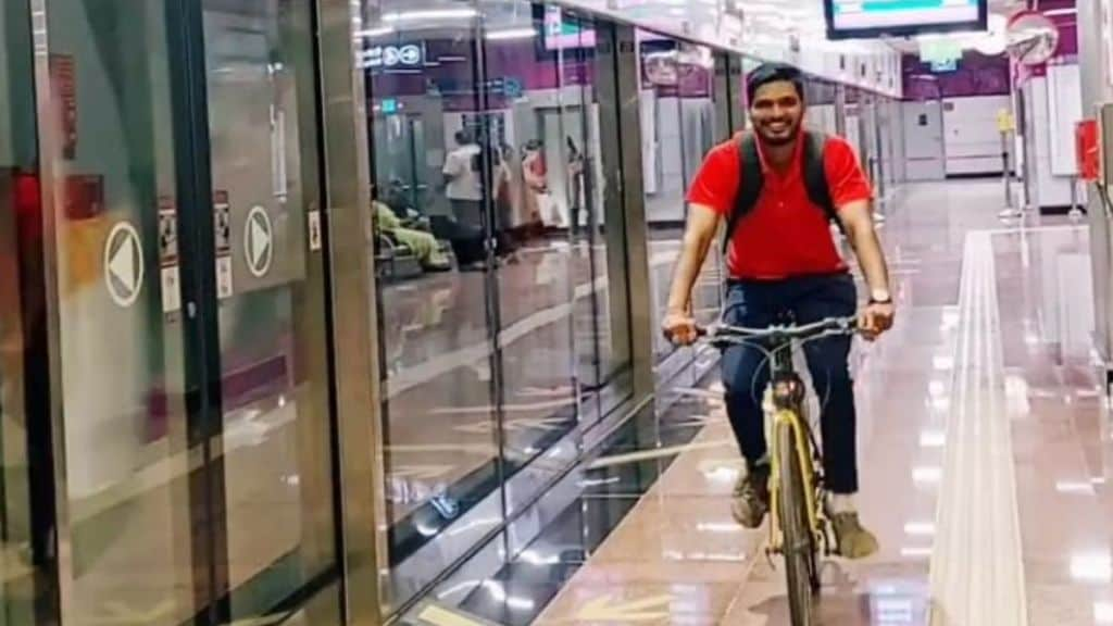 young man riding bicycle in a metro station