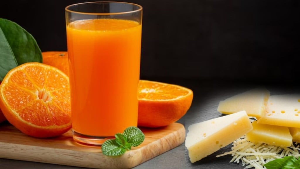 Man drinks orange juice with slice of cheese