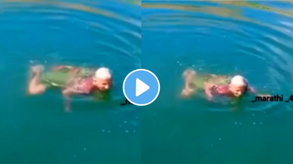 old lady wearing nauvari swimming in a river