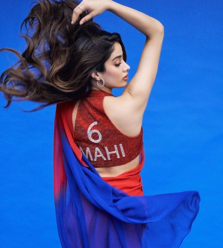 Janhvi Kapoor has taken the internet by storm with her promotional looks for her upcoming movie Mr. & Mrs. Mahi which is based on cricket. She is seen wearing a red and blue Manish Malhotra saree which are the colours of her character's jersey, along with a shimmery red blouse which had her character's jersey number and name on the back. (Photo: Instagram/@janhvikapoor)