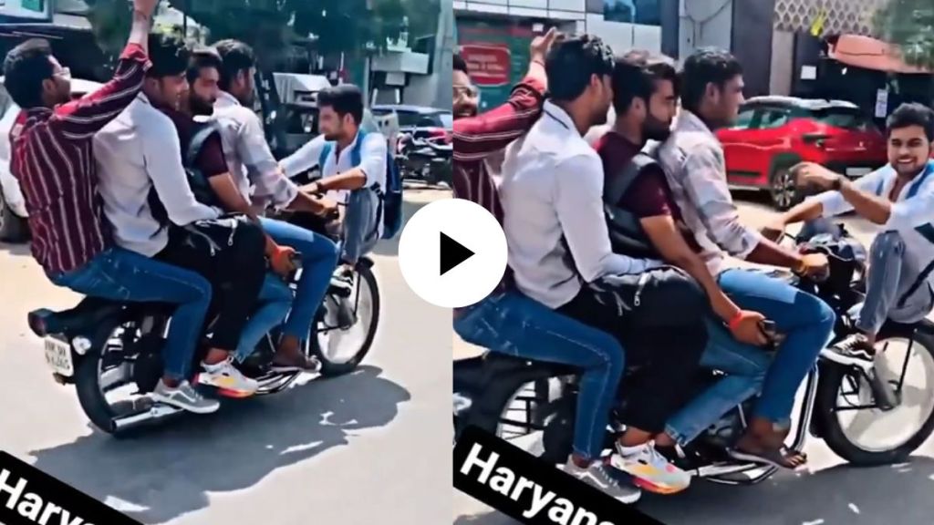 five young boys doing stunt on moving bike on a road