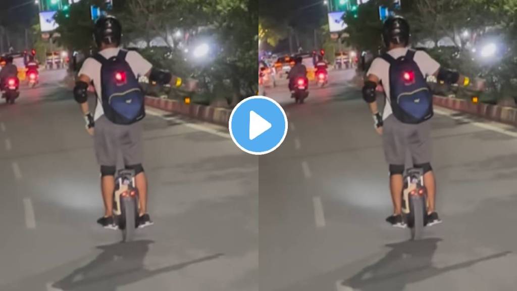 Man Riding Unicycle and balancing a cycle bearing just one wheel on the roads of India people caught the incident on camera