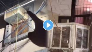 man pointing at a pipe extending from the AC unit pipe runs down the building and into an air cooler redirected jugaad video