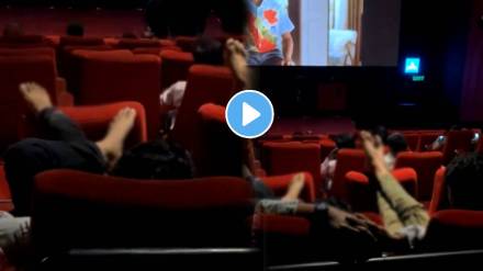 In a movie theatre person filming several audience resting their feet on the front seats in a PVR multiplex watch ones viral video