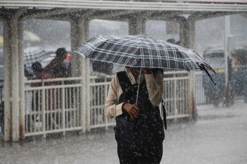 Pedestrians experience sudden rain at Bandra,