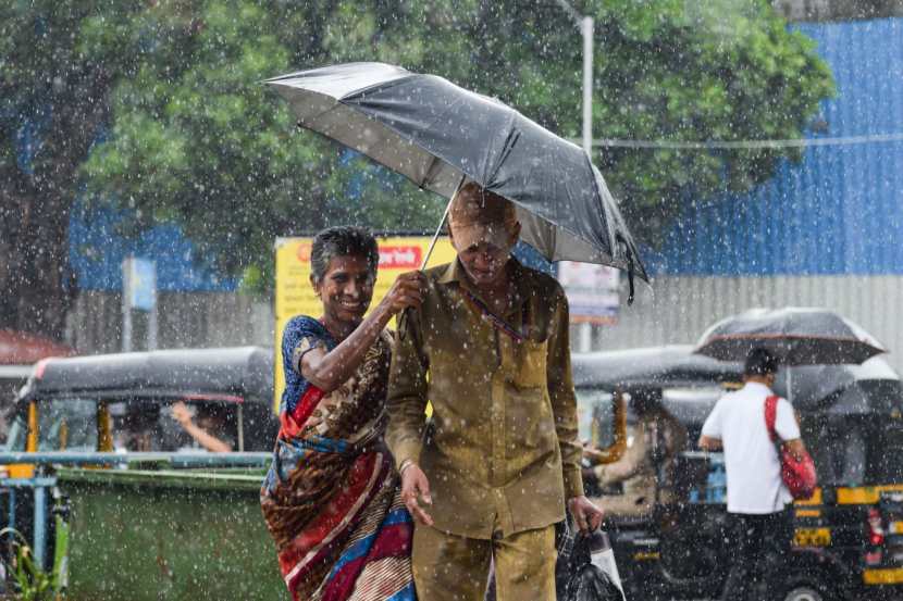 Pedestrians experience sudden rain at Bandra,