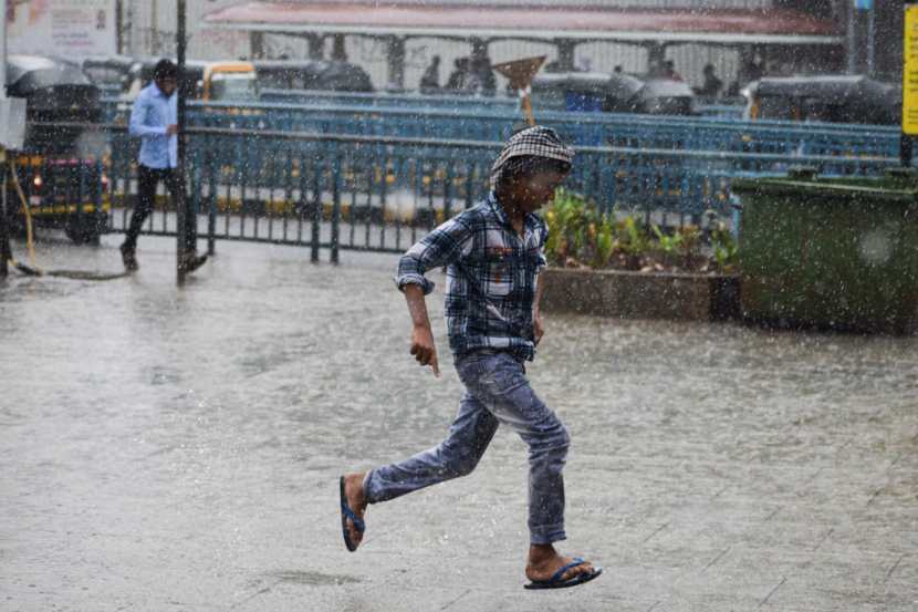 Pedestrians experience sudden rain at Bandra,