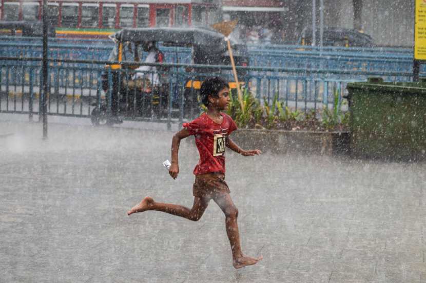 Pedestrians experience sudden rain at Bandra,