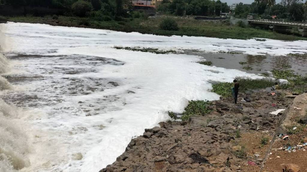 foam on the water of indrayani river ahead of palkhi ceremony