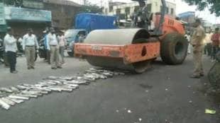 police crush high sound silencers with road roller in gadhinglaj