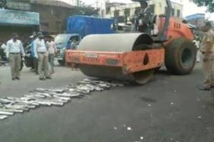 police crush high sound silencers with road roller in gadhinglaj
